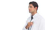Smiling doctor holding up stethoscope to his chest