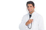 Happy doctor holding up stethoscope to his chest