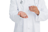 Doctor holding medicine and glass of water