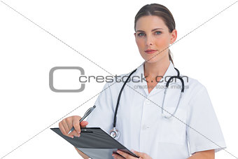 Nurse holding clipboard and looking at camera