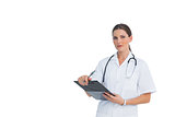 Nurse holding clipboard and looking at camera with large copy space