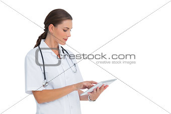 Nurse using her tablet and smiling