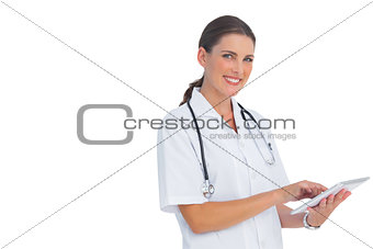 Smiling nurse using her tablet