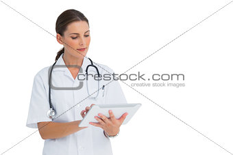 Happy nurse working on her tablet