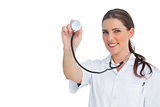 Happy nurse holding up stethoscope