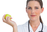 Nurse smiling and holding an apple