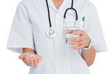 Nurse holding medicine and glass of water