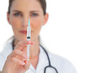 Nurse holding a syringe up