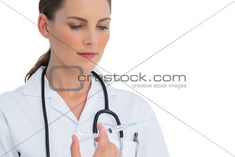 Serious nurse holding a syringe