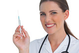 Happy nurse holding a syringe and smiling