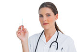 Stern nurse holding a syringe