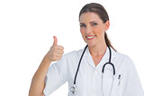 Happy nurse giving thumbs up and smiling at camera
