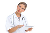 Confused nurse with tablet pc