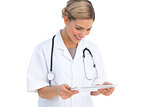 Smiling nurse looking at tablet pc