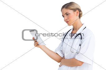 Confused nurse holding tablet pc
