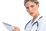Serious nurse with tablet pc
