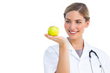 Nurse looking at the apple placed on her hand