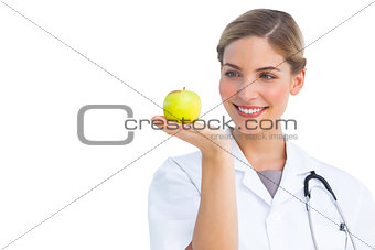 Nurse looking at the apple placed on her hand