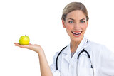 Laughing nurse with apple on her hand