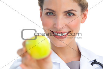 Focus shot on nurse holding apple