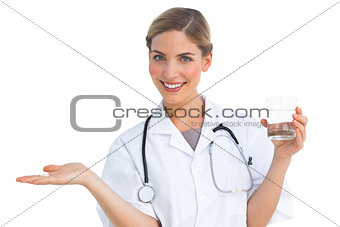 Nurse offering drugs and water glass