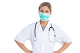 Nurse wearing surgical mask with hands on hips