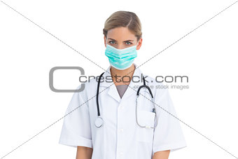 Serious nurse wearing surgical mask