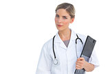 Serious nurse holding clipboard