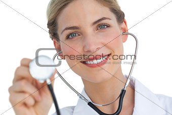 Smiling nurse using stethoscope