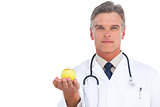 Doctor showing green apple