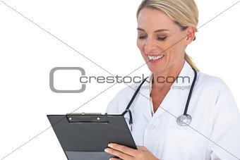 Doctor writing on a clipboard and smiling