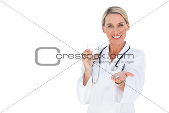 Smiling doctor holding out pills and water glass