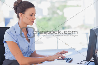 Serious businesswoman working on her computer