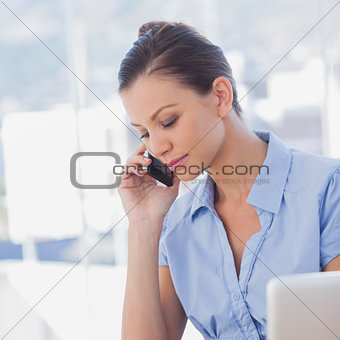 Businesswoman calling with her mobile phone