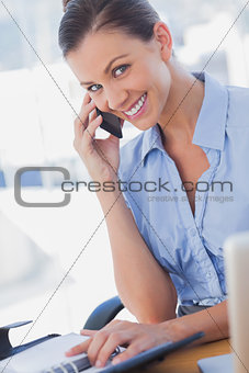 Happy businesswoman calling and smiling