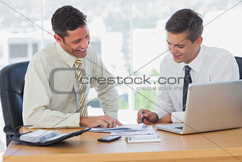 Happy businessmen working together and smiling
