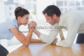 Business people arm wrestling