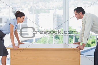 Business people facing off at desk