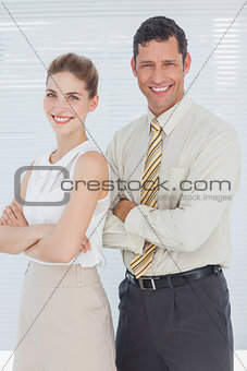 Business people smiling with arms crossed