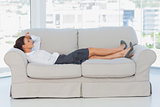 Business woman lying down on the couch