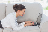 Business woman using laptop on couch