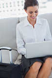 Happy business woman using laptop