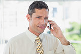 Smiling businessman on the phone