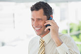 Laughing businessman on the phone