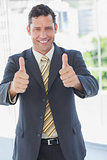 Happy businessman with thumbs up