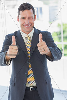 Happy businessman with thumbs up