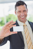 Businessman showing a white business card