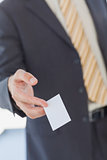 Businessman giving a white blank business card
