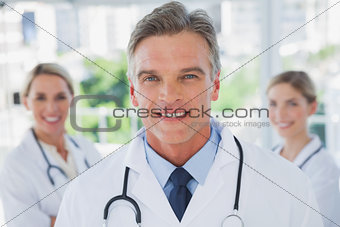 Charismatic doctor standing with colleagues