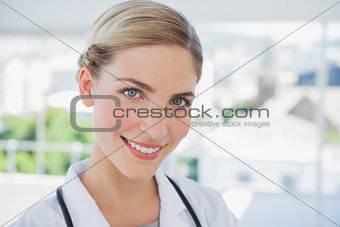 Smiling doctor standing in her office